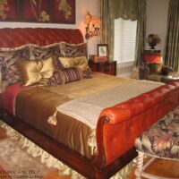 leather bed frame and gold bed spread